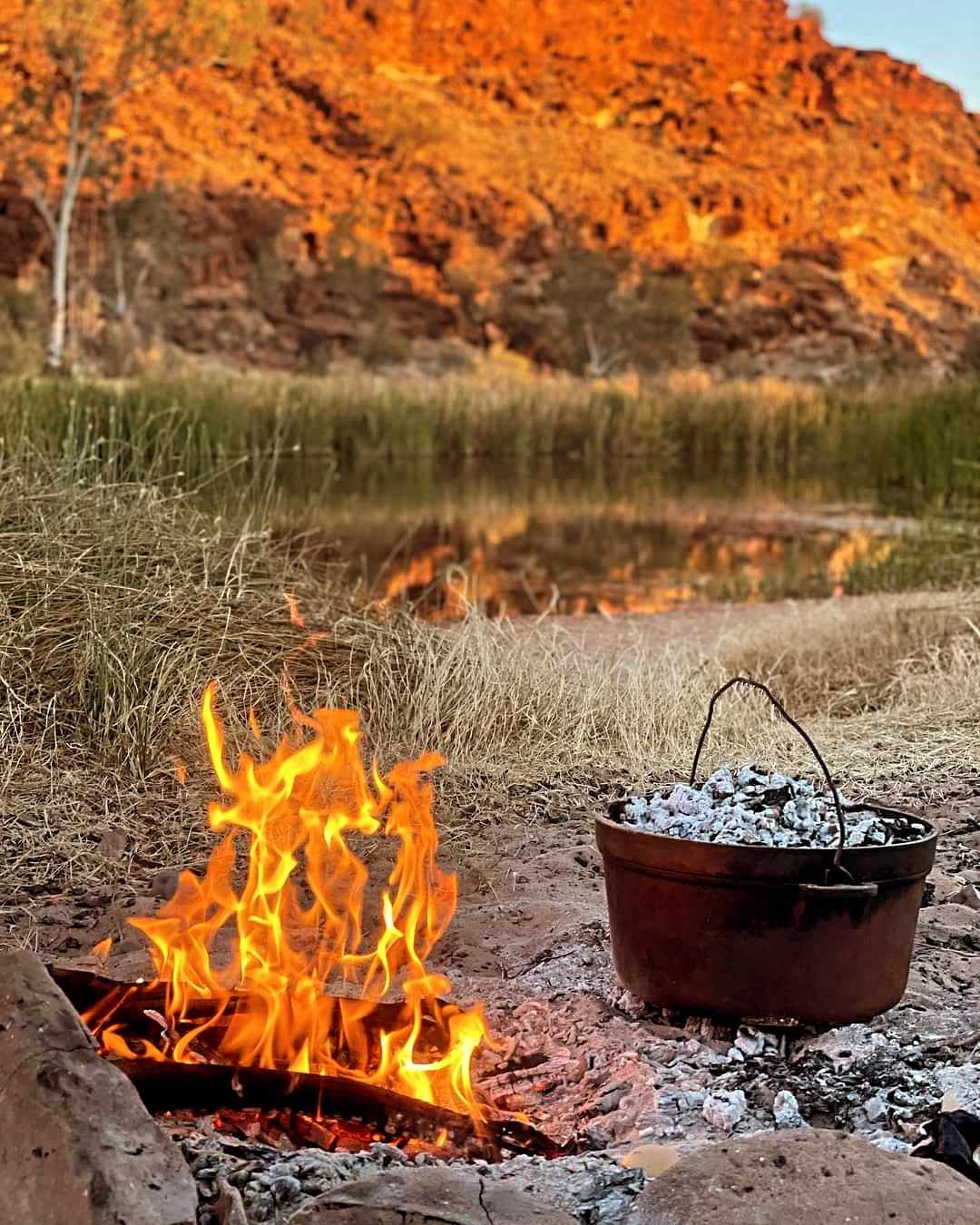 Sustainable Camping: Best Camping Tips for 2024 low Impact Camp Over recycling the campfire to cook.